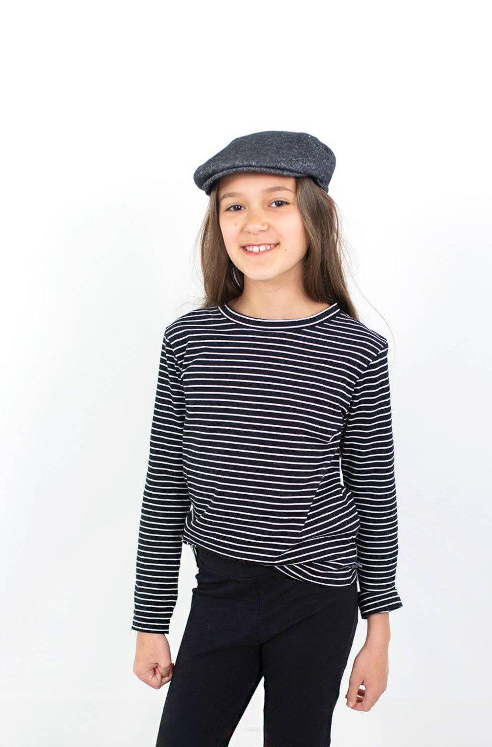 Girl wearing white and black stripe organic cotton long sleeve shirt.  Perfect for capsule wardrobes.