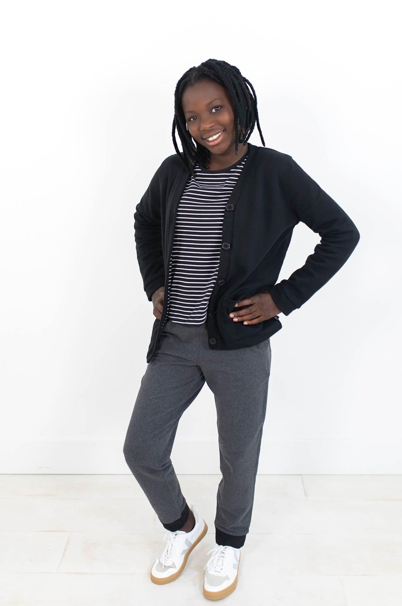 Girl wearing black cardigan made from organic cotton.  Author Clothing is ethically made.