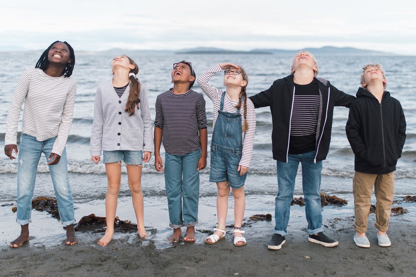 kids in organic Author Clothing look up at sky