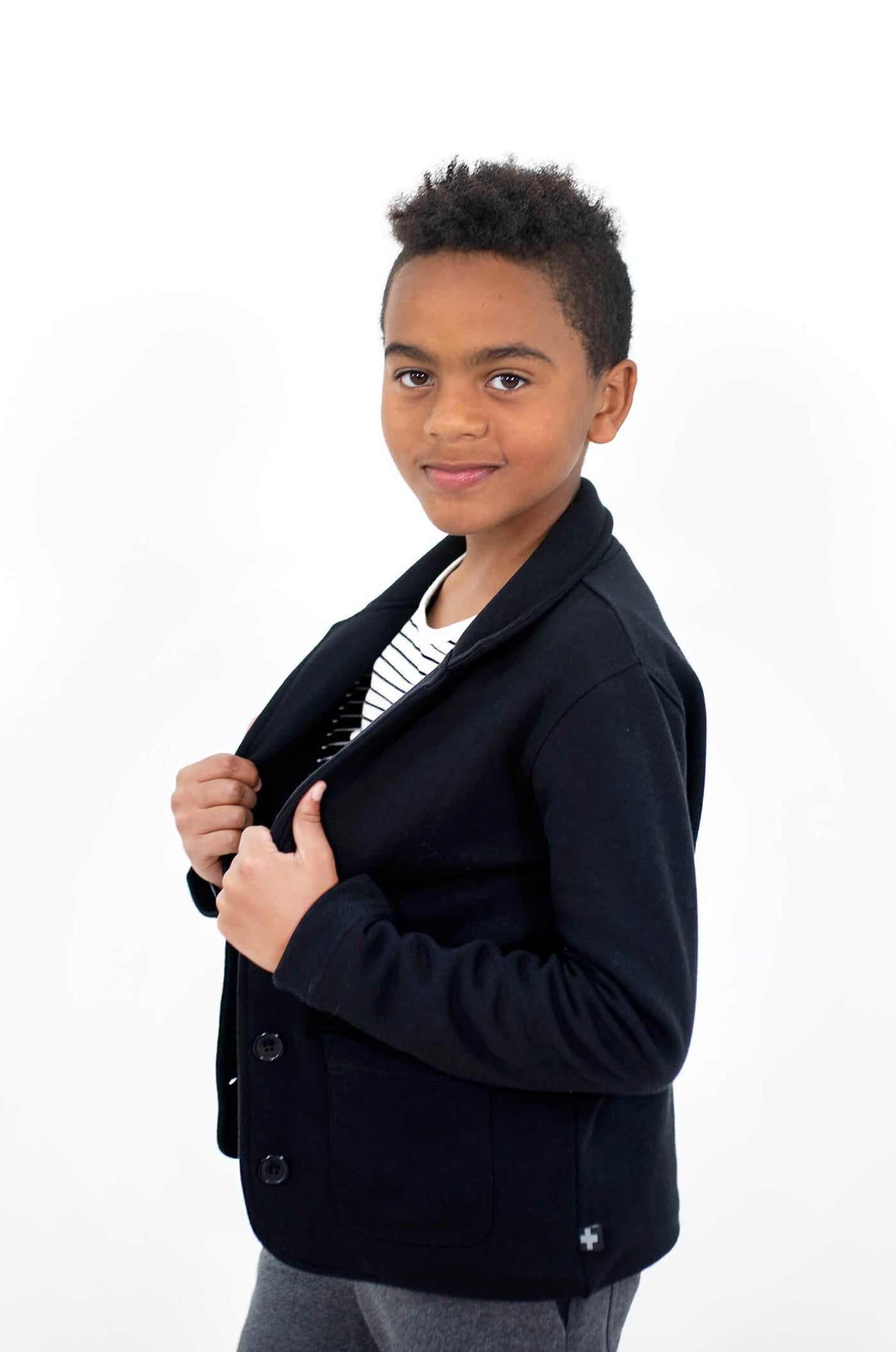 Boy wear black blazer made from organic cotton.  Author Clothing is ethically made and designed in Canada.