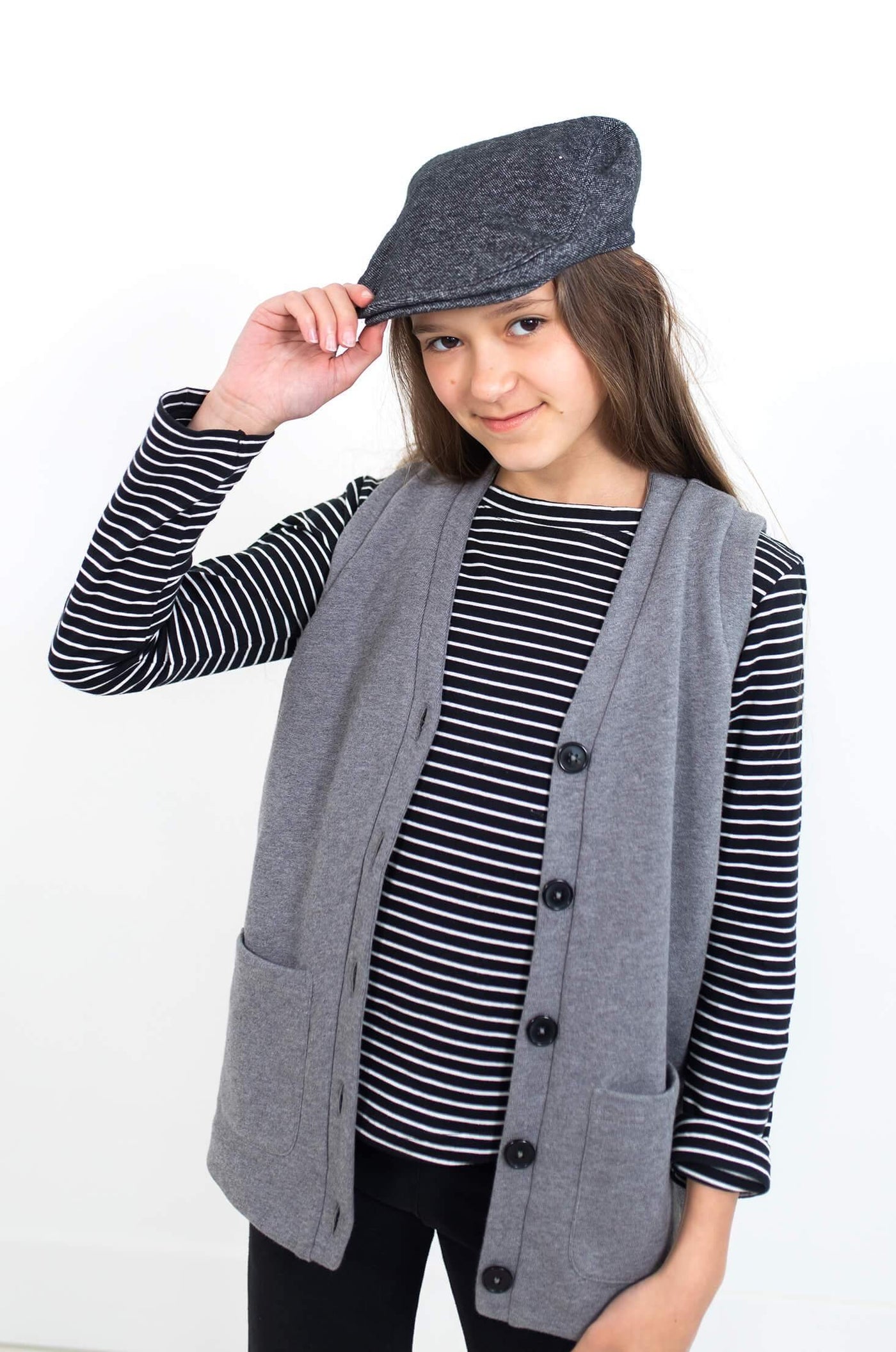 Girl wearing grey vest.  Ethically made with organic cotton.  Designed in Canada.