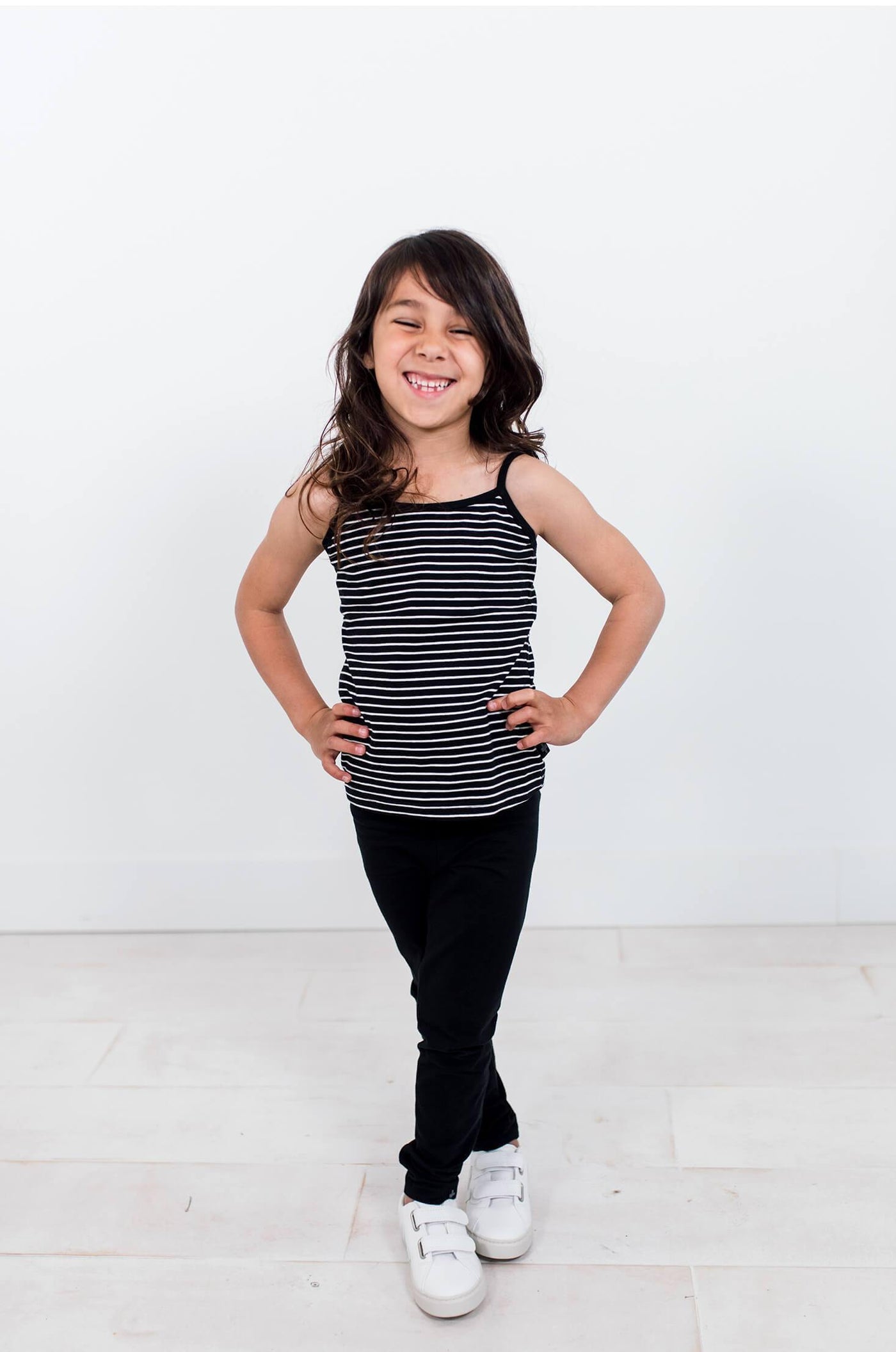 Girl wearing black organic cotton legging.  Ethically made designed in Canada.