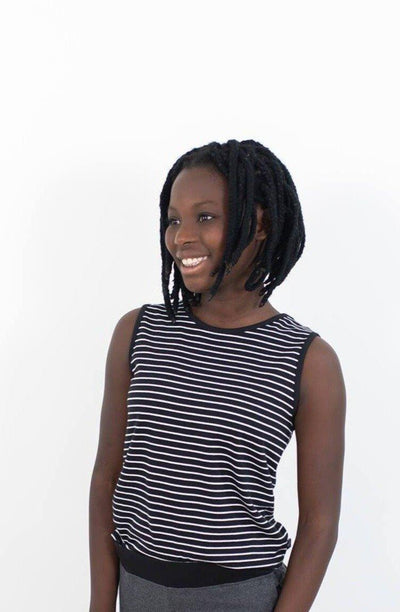 Smiling girl wearing black 100% organic cotton tank with white stripes.  Perfect for capsule collections.