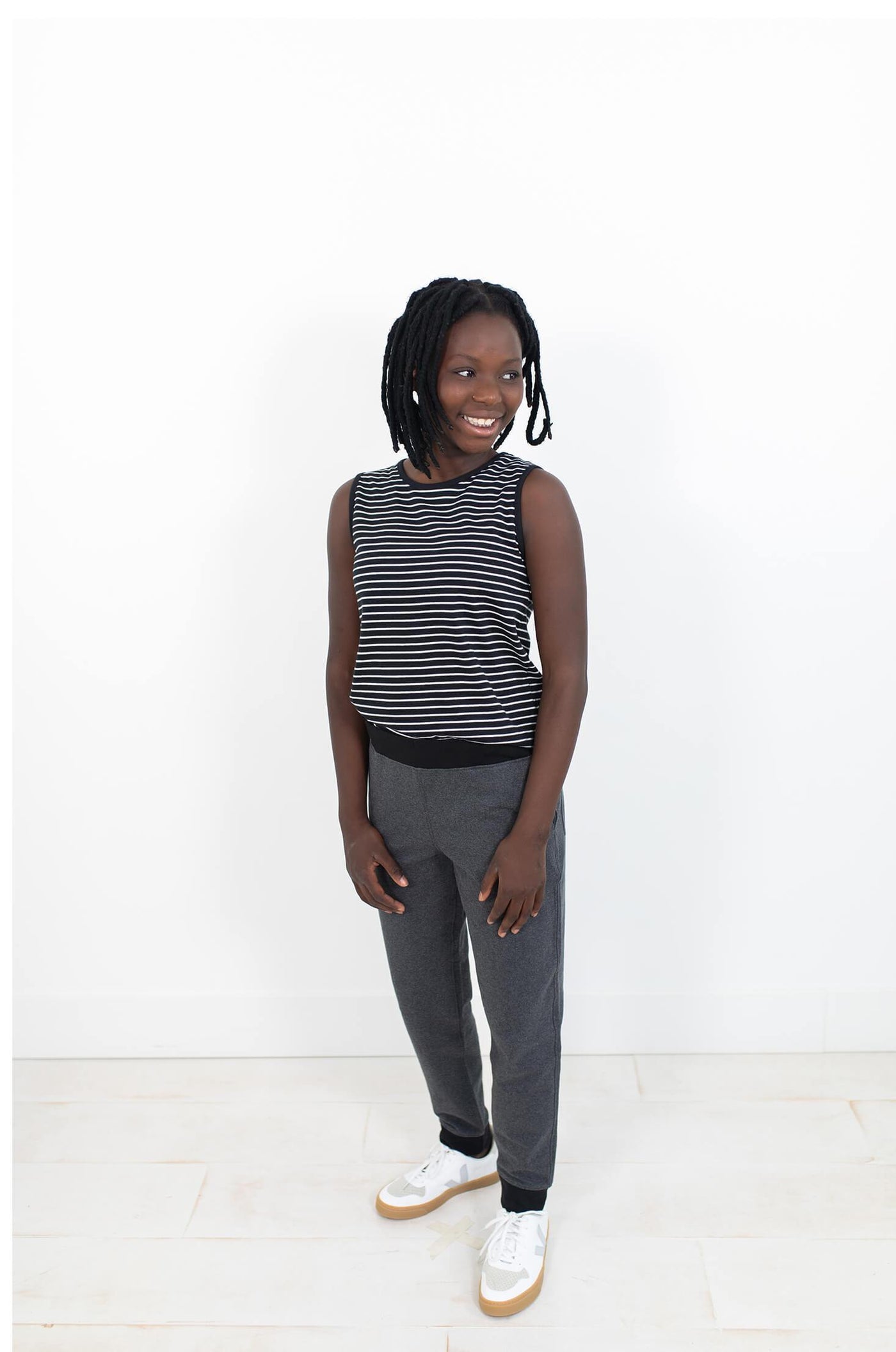 Girl wearing black and white striped tank ethically made from 100% organic cotton.  Designed in Canada.